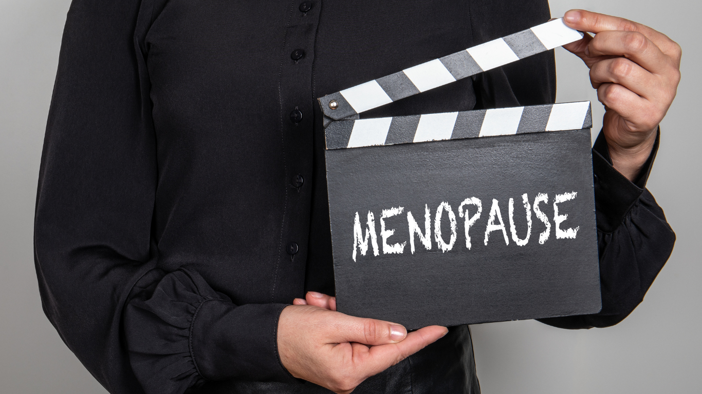 hand holding a sign that says menopause