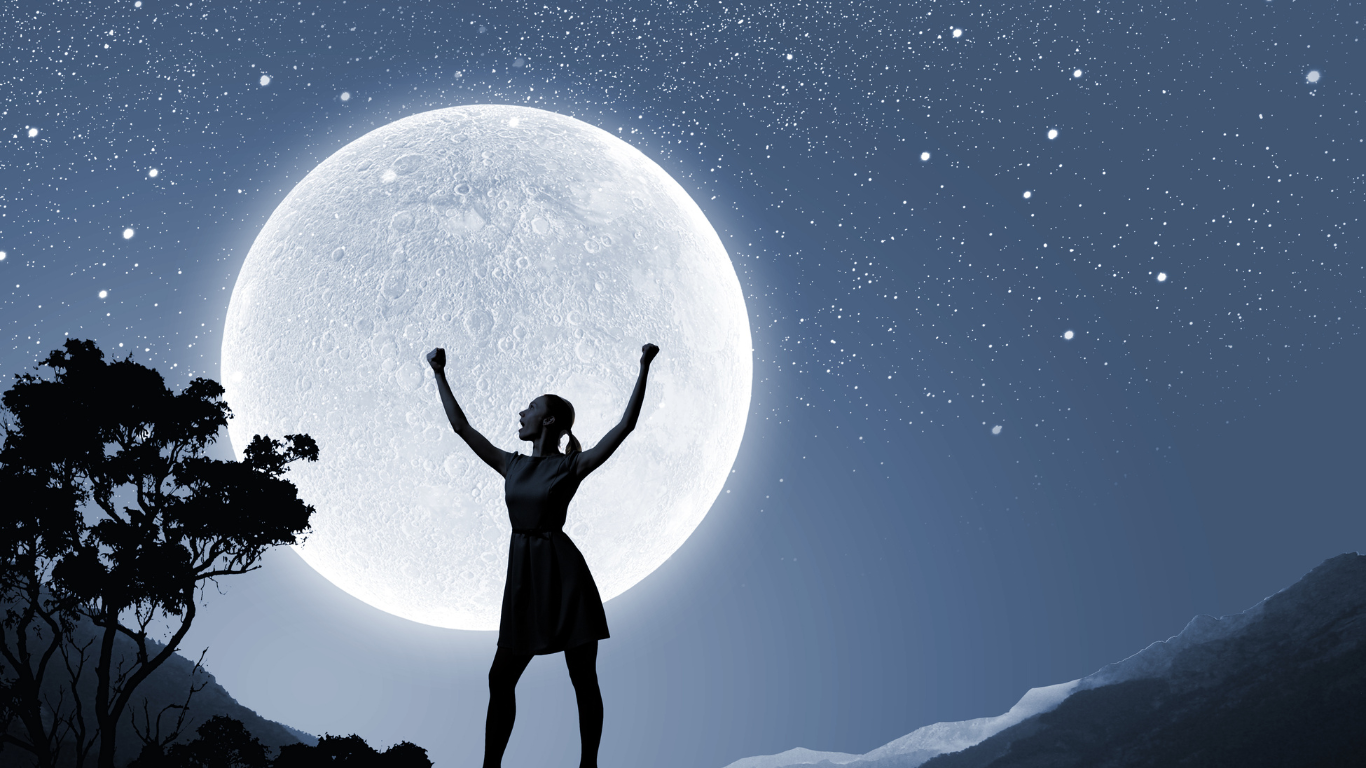 Strong woman standing in front of the moon
