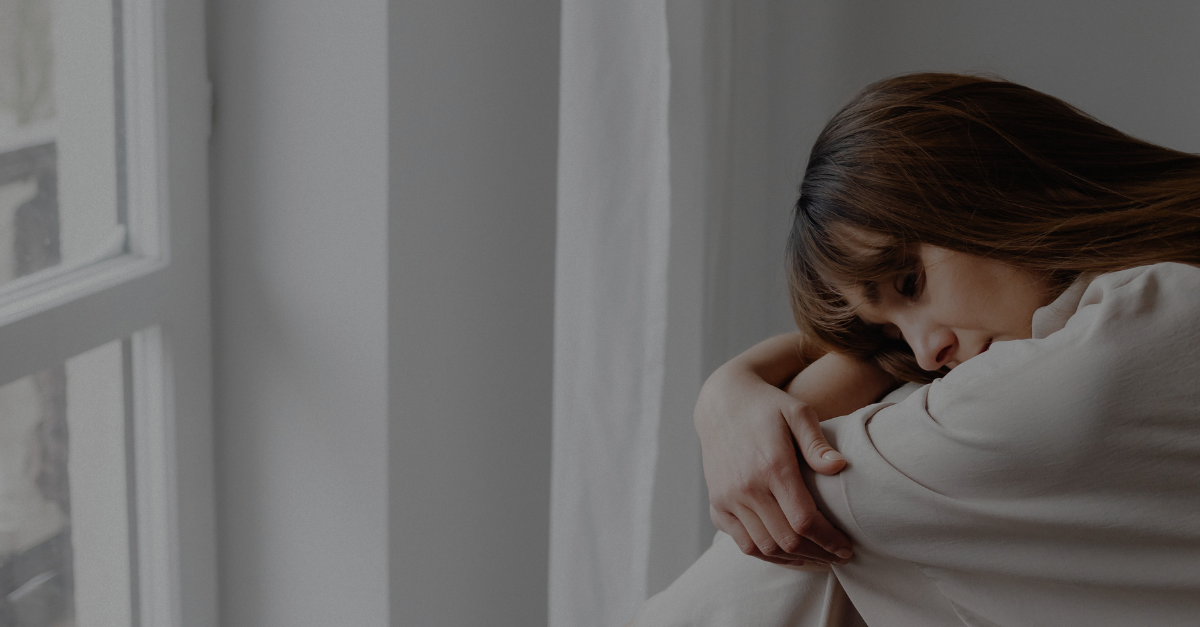 Woman experiencing menopause symptoms and reflecting on hormone health, wellness, and emotional well-being during midlife transition.